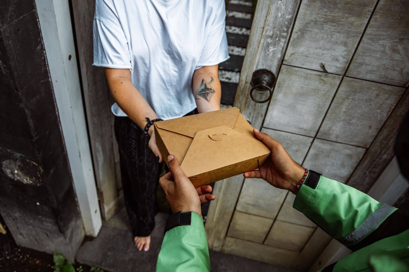 A rider handing the parcel over at the buyer’s door